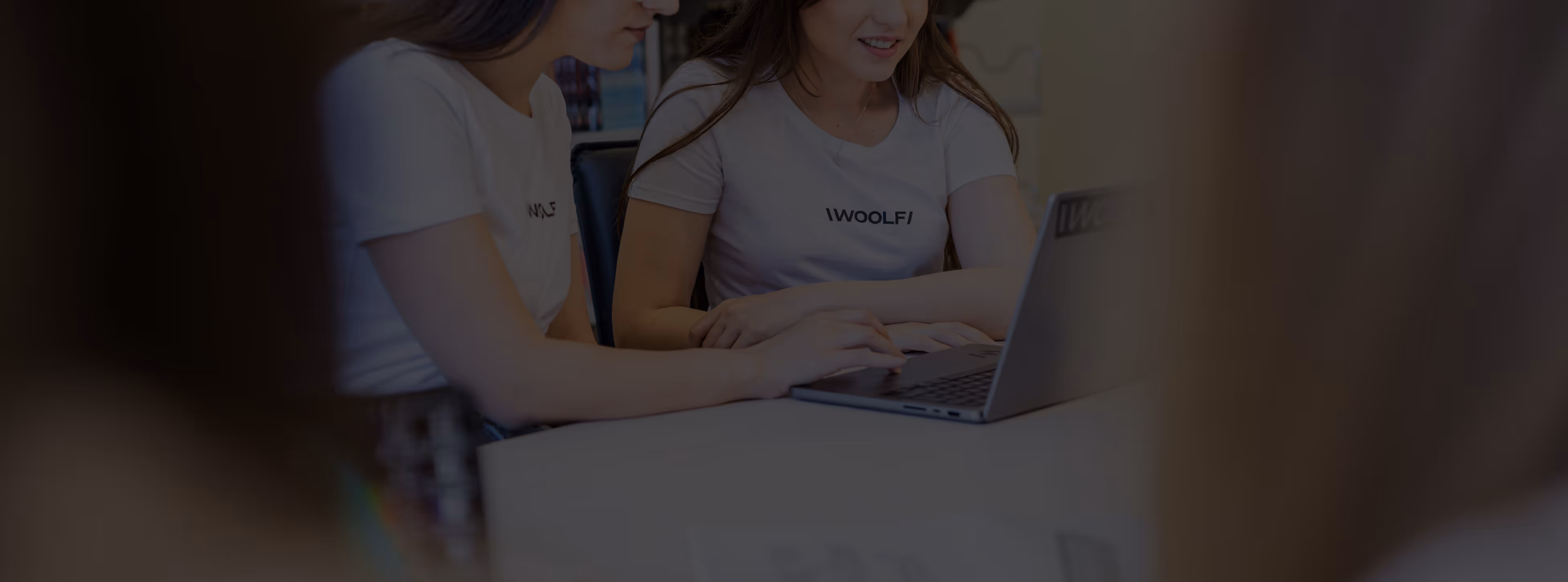 Dark image with woman working on laptop